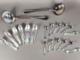a lot of silver spoons and spoon spoons on the table