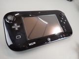 a black nintendo wii game system sitting on a table