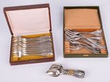 a lot of silver spoons and forks in a box