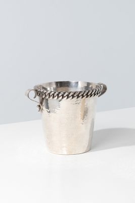 silver plated ice bucket with rope handles on a white surface