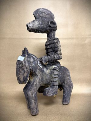 statue of a man riding a horse with a dog on its back