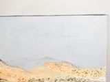 a painting on the wall of a desert with mountains in the background