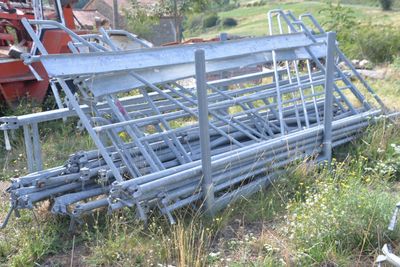 a pile of metal pipes in the middle of a field