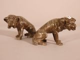 pair of bronze figurines of two dogs with tags on their ears