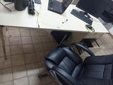 a desk with a chair and a computer on it