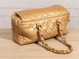 a gold purse sitting on a wooden table