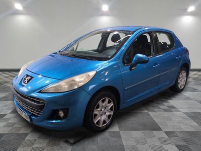 une voiture bleue est garée dans une pièce au sol à carreaux
