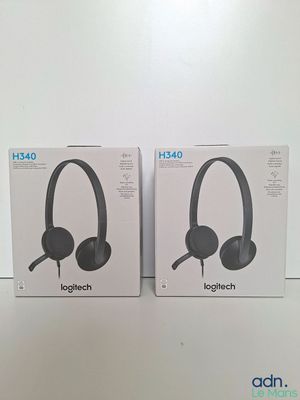 two boxes of headphones sitting on top of a white table