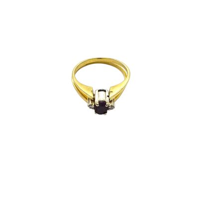 an image of a gold ring with a black stone in the middle
