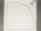 a close up of a white handkerchief with a golden line