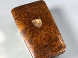 a small wooden box sitting on a white surface