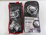 two bags of venumm boxing gloves on a white surface