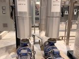 two blue pumps sitting on top of a pallet in a warehouse