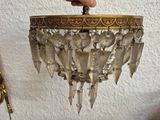 a person that is holding a chandelier in their hand