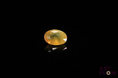 a yellow diamond in the dark