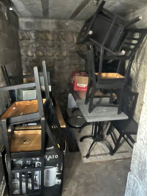 a room with a bunch of chairs and a table in it