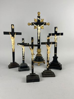 three black and gold crucifs with jesus on the cross