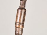 a statue of a man holding a cane on a table