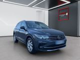 a blue volkswagen suv parked in a showroom
