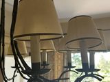 a chandelier that has a bunch of lamps hanging from it