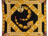 a black and gold scarf with elephants and flowers on it
