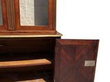 an old wooden cabinet with a mirror on top of it