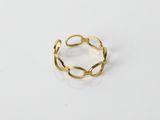 a gold plated ring on a white surface