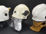 several different types of helmets are lined up on a black surface