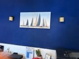 a picture hanging on the wall of a blue room