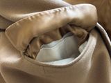 a close up picture of a tan blanket with a pocket