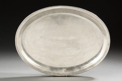 a silver plate sitting on a table with a black background