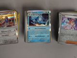 Quatre types différents de cartes Pokémon sont alignées sur une table
