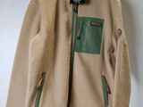 an image of a jacket hanging on a wall with a tag on it