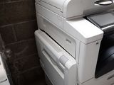 a white printer sitting on top of a stack of drawers