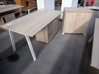 two desks and a filing cabinet in a room