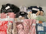 many different types of clothing on a shelf together