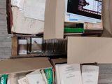 a box full of books and papers sitting on the floor