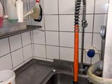 a sink in a small kitchen with a metal faucet