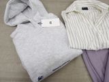 two shirts that are sitting next to each other on a bed