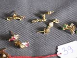 a lot of small gold earrings on a table