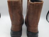 brown leather boots with black soles on a white surface