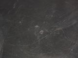 a spider web in the middle of a black table