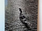 a black and white photo of a man in a boat