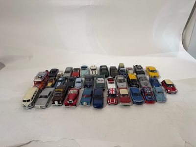 a lot of toy cars sitting on a white surface