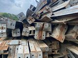 pile of steel beams in a junkyard