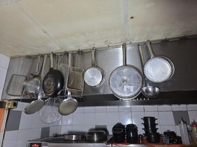 des casseroles et des poêles suspendues au plafond dans une cuisine