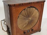une vieille radio en bois surmontée d'un ventilateur