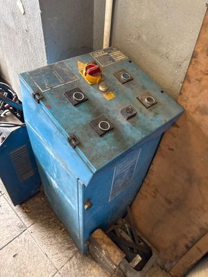 a blue machine that is sitting in the corner of a room