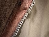 the zipper of a bag is open on a white surface