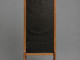 a wooden easer with a blackboard on wheels on a gray background